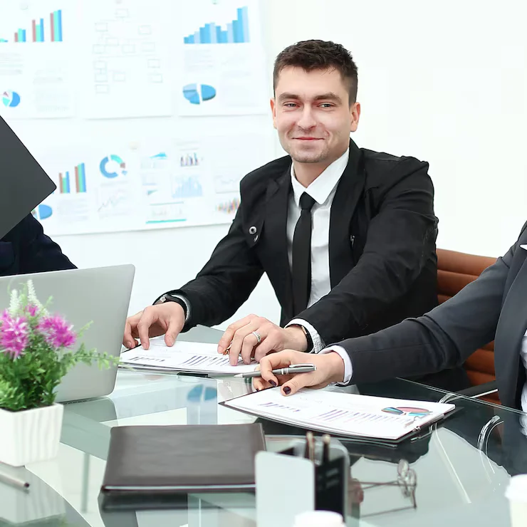 A man sitting at the table with a bunch of papers in their hands