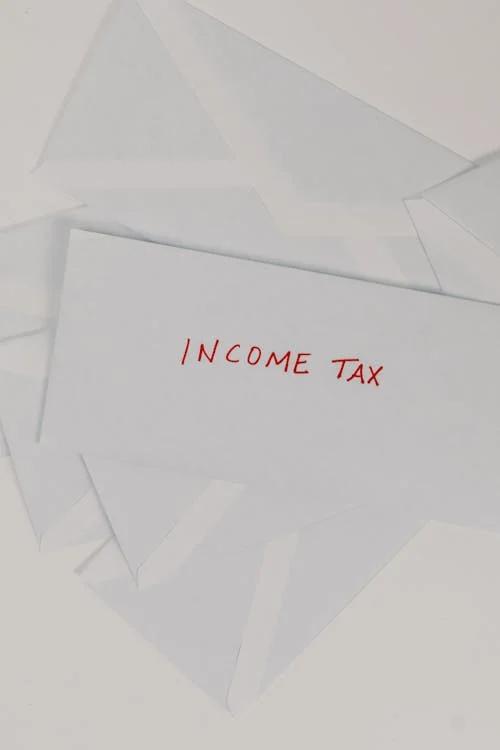 An envelope with the word’s income tax over it.